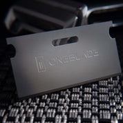 OneBlade Safety Razor Blade on metal texture