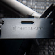 OneBlade Safety Razor Blade balancing on stand