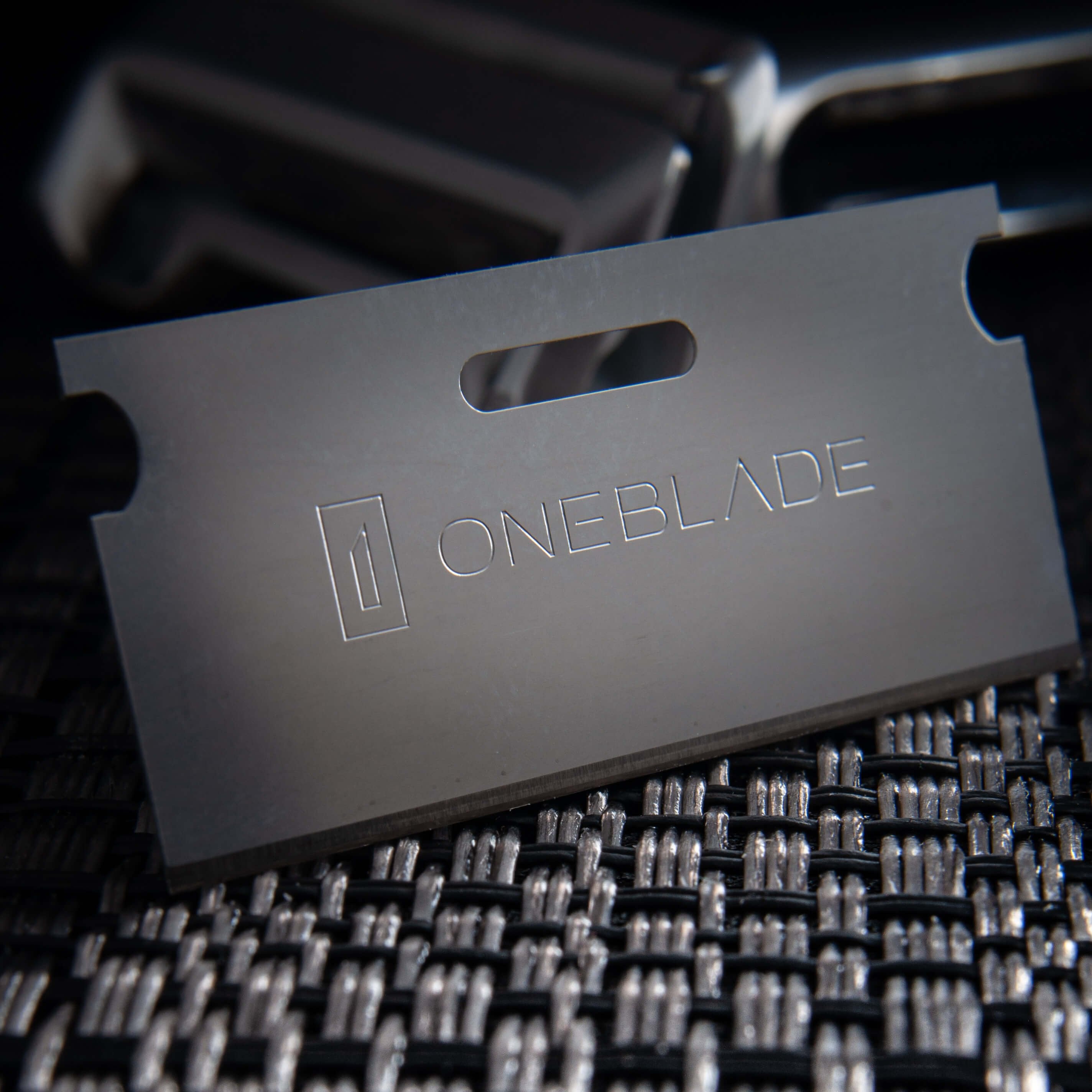 OneBlade Safety Razor Blade on metal texture