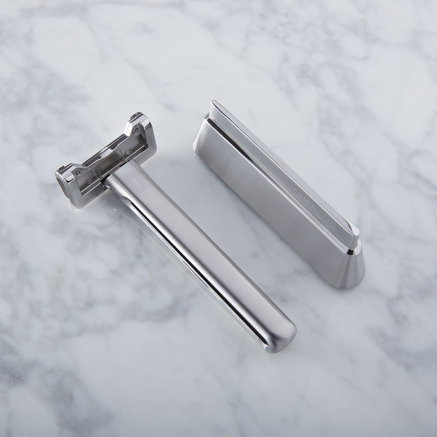 GENESIS Single Blade Safety Razor sitting next to matching stand
