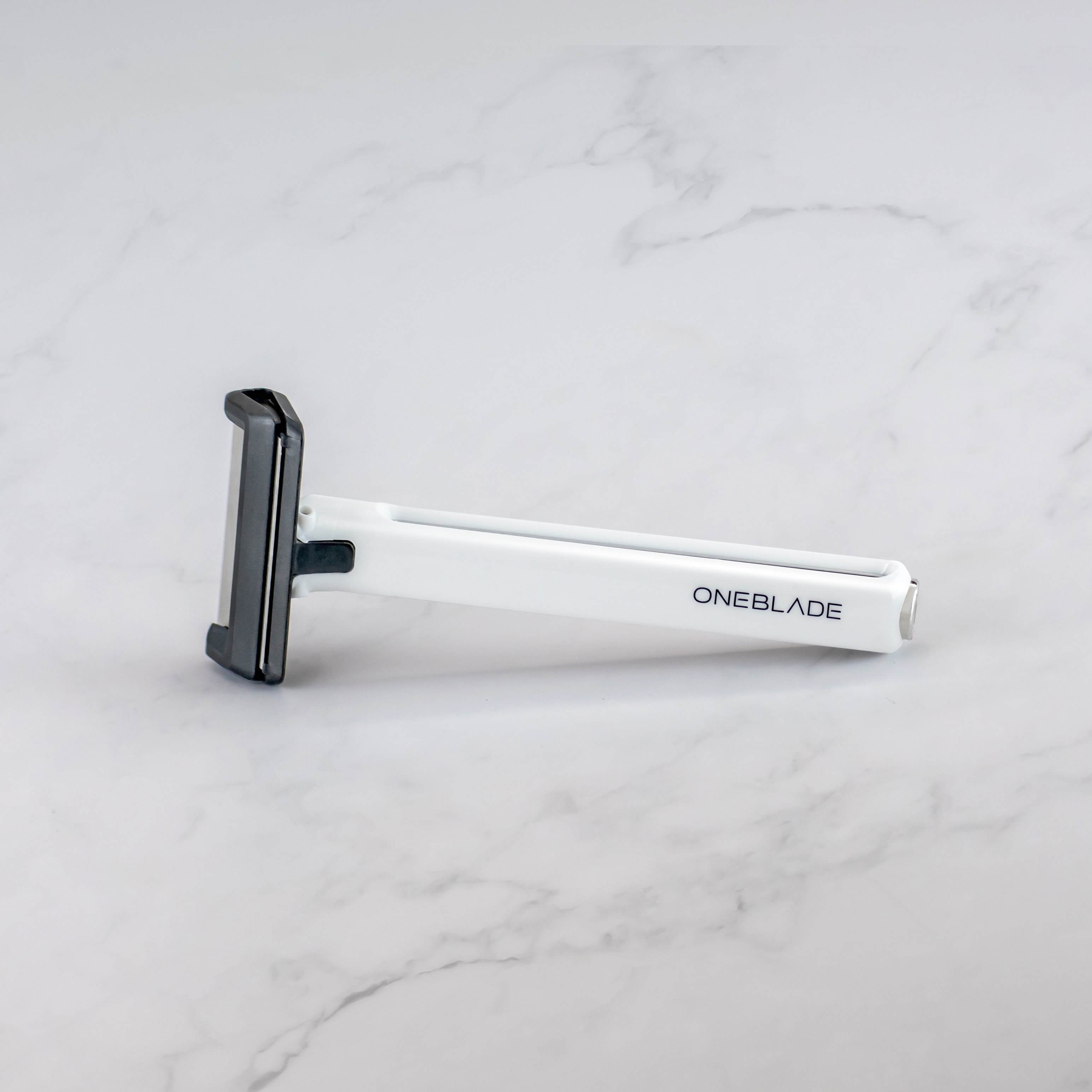 A white Core single blade safety razor on marble surface