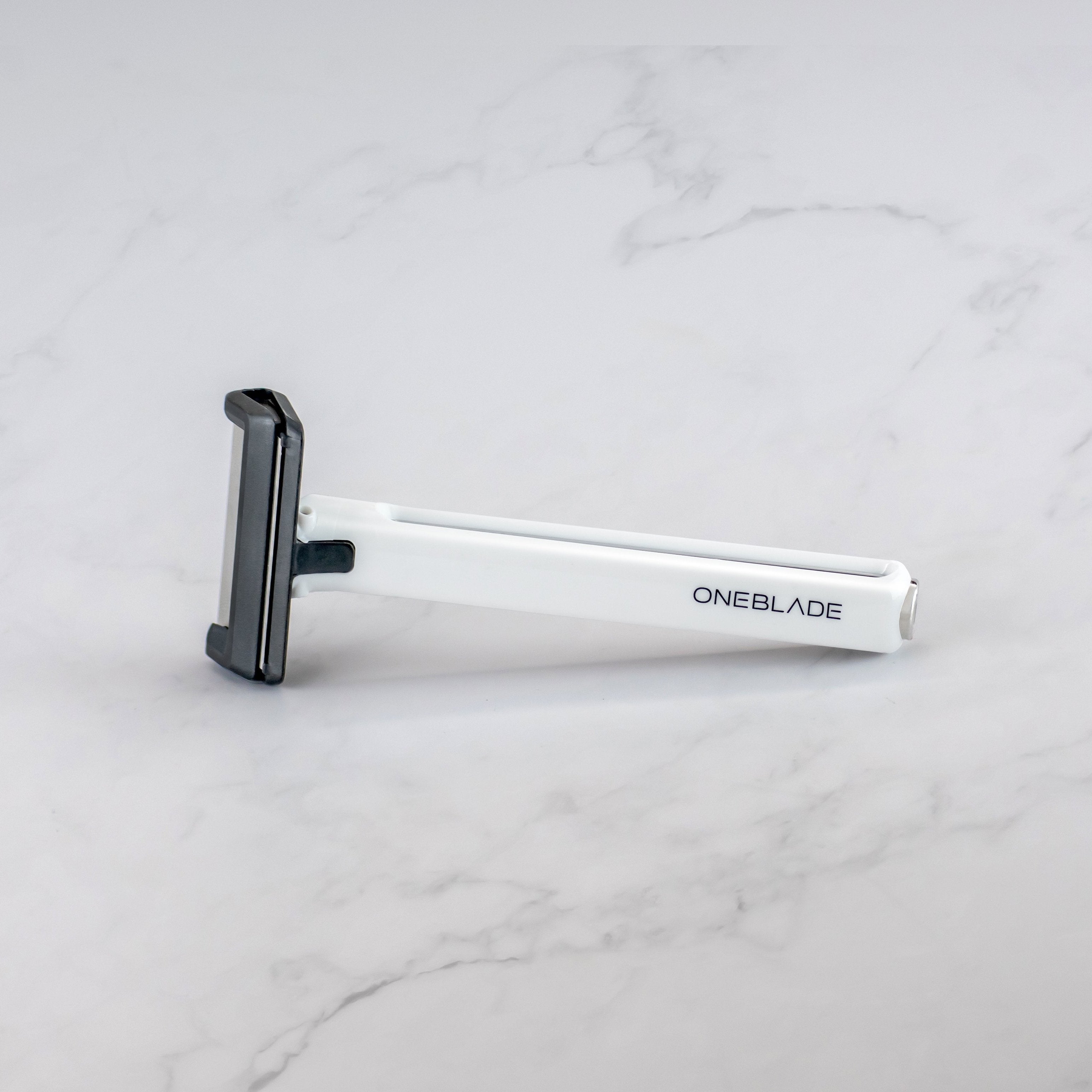 a white Core Safety Razor on a marble background